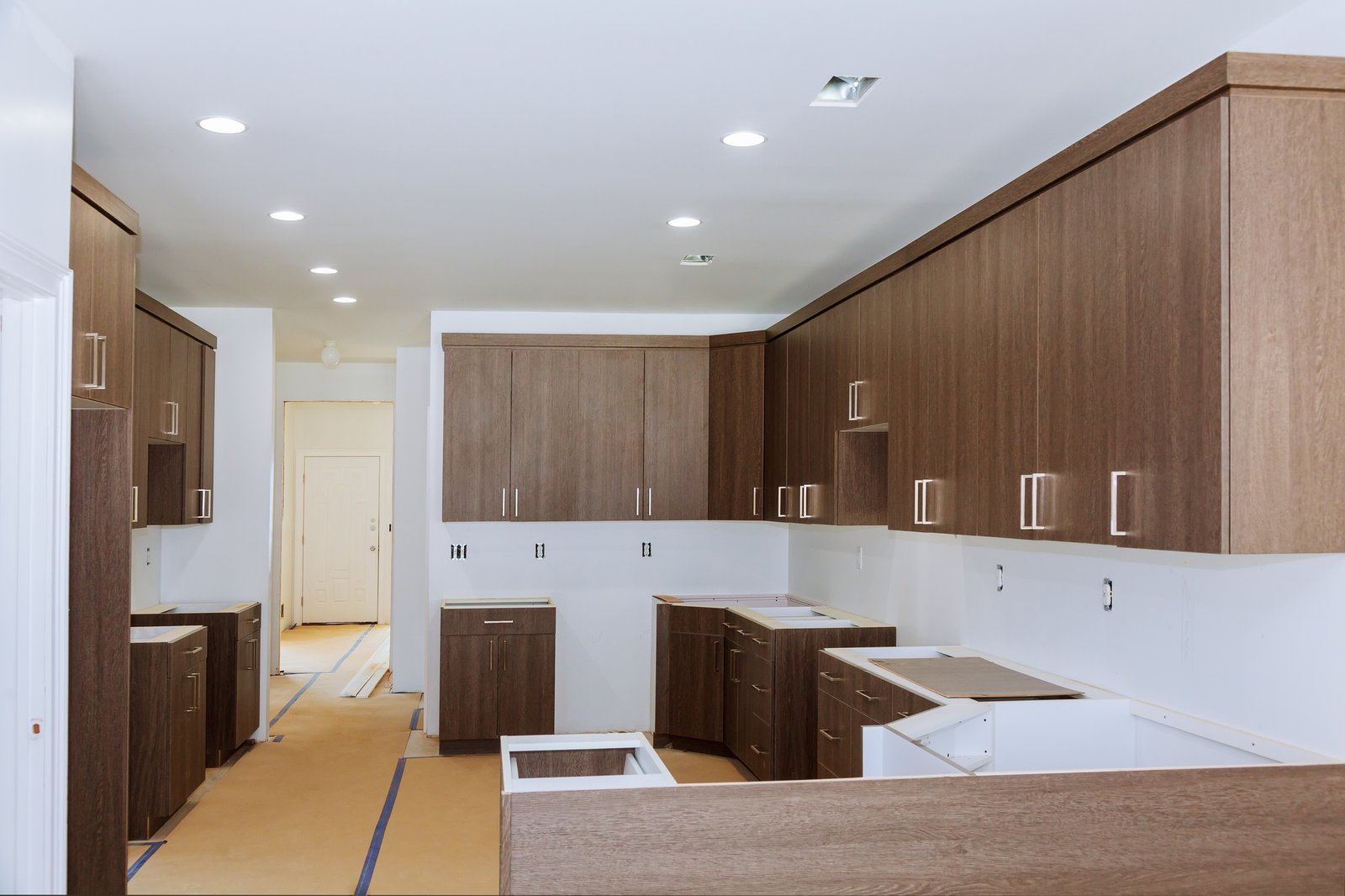 Custom kitchen cabinets in various stages of installation base for island in center